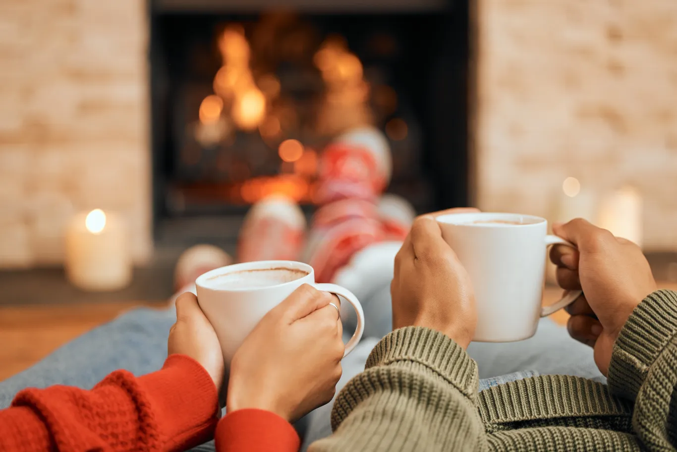 A gas insert burning in a brick fireplace with a white mantel